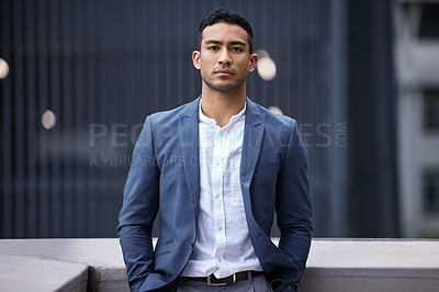 Buy stock photo Cropped portrait of a handsome young businessman standing on a balcony with his hands in his pockets