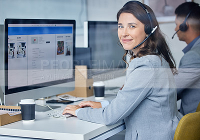 Buy stock photo Cropped portrait of an attractive young female call center agent working at her desk