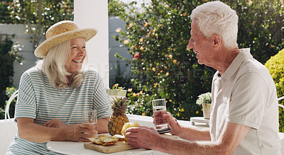 Buy stock photo Senior, couple or pineapple on patio with water for retirement, planning vacation for anniversary. Husband, wife or old in garden for talk with drink, sunshine in summer with partner in home for chat