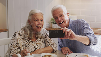 Buy stock photo Elderly couple, smartphone and selfie in kitchen in home with smile, retirement or bonding in marriage. Morning, cellphone and social media for profile picture, video call or mature people with tech