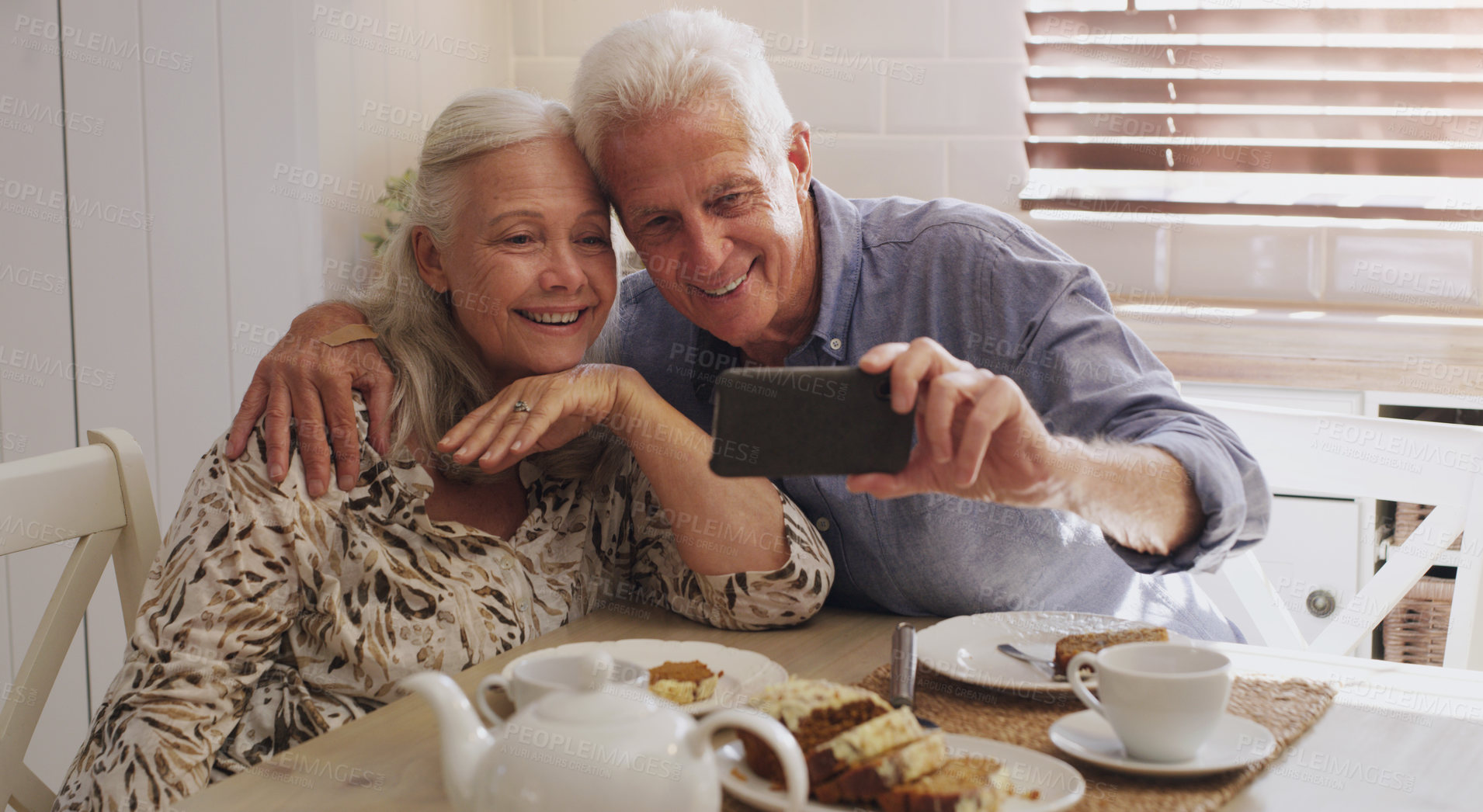 Buy stock photo Elderly couple, love and selfie in kitchen in home with smile, retirement or bonding in marriage. Morning, happy and social media for profile picture, video call or mature people with breakfast