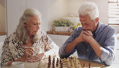 Buy stock photo Home, mature couple and chess game on table in kitchen with strategy, thinking and mental exercise. Elderly people, competition and problem solving for man or woman, challenge or checkmate to relax