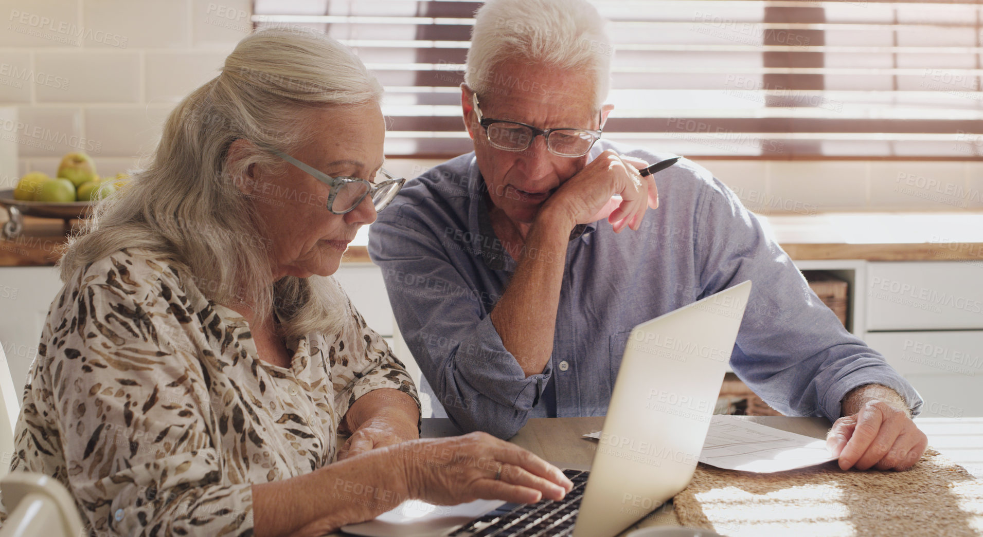 Buy stock photo Elderly couple, laptop and kitchen for research, financial budget and online investment for mortgage payment in retirement. Man, woman and serious with tech for planning strategy for internet banking