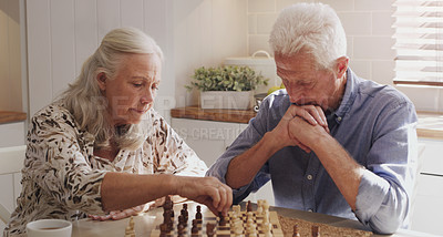 Buy stock photo Senior, retired and couple at home with chess on board game by bonding, thinking and strategy for decision. Elderly,  man and woman in kitchen with love, relax and trust for challenge of skills
