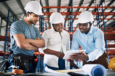 Buy stock photo Shot of a group of builders having a meeting at a construction site