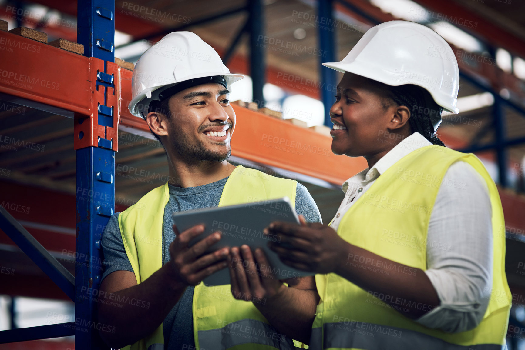 Buy stock photo Shot of two builders using a digital tablet while working at a construction site