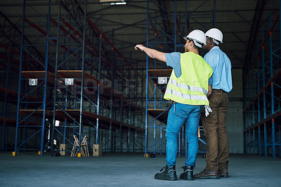 Buy stock photo Shot of two builders inspecting a construction site