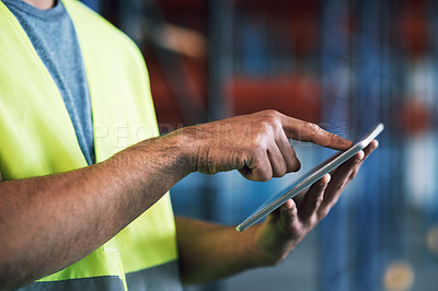 Buy stock photo Shot of a builder using a digital tablet while working at a construction site