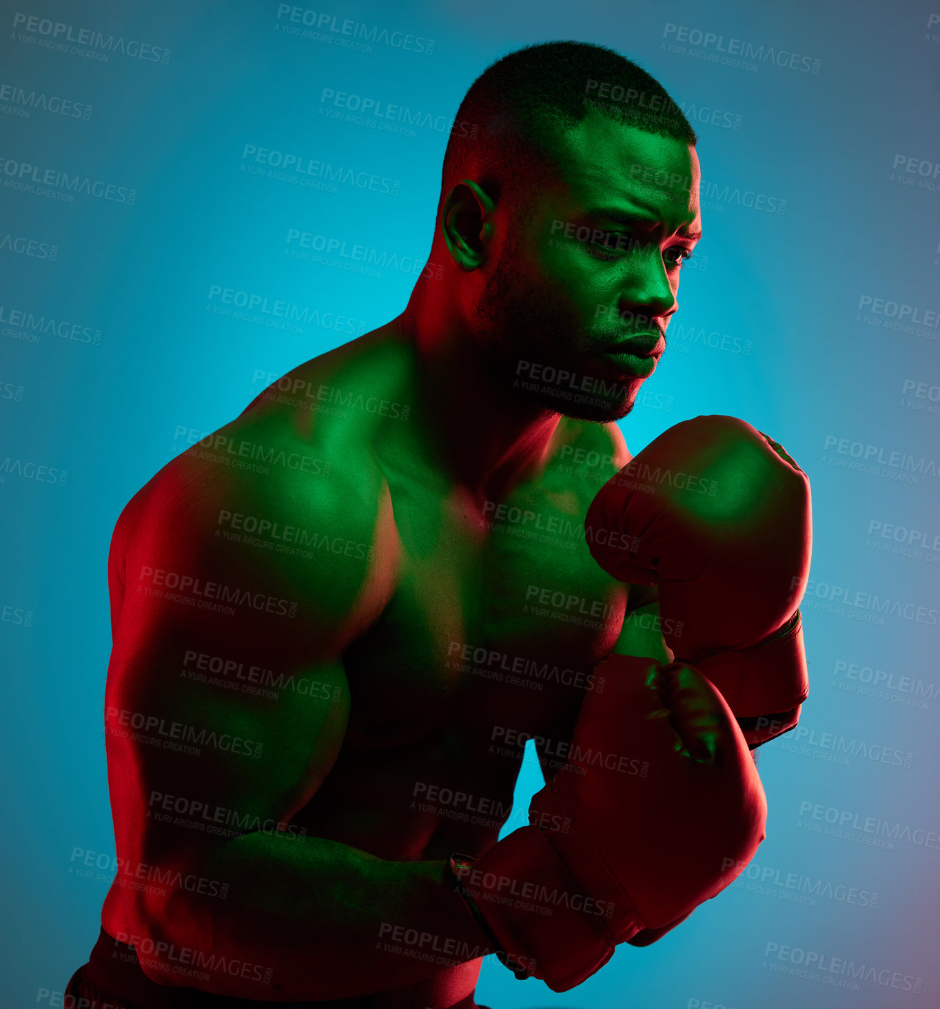 Buy stock photo Studio shot of a sporty young man wearing boxing gloves