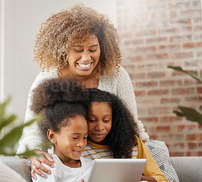 Buy stock photo Family, together and tablet watch video for education, gaming or streaming in living room sofa in home. Happy, mother and daughters laughing with tech in house for homework, study and bonding