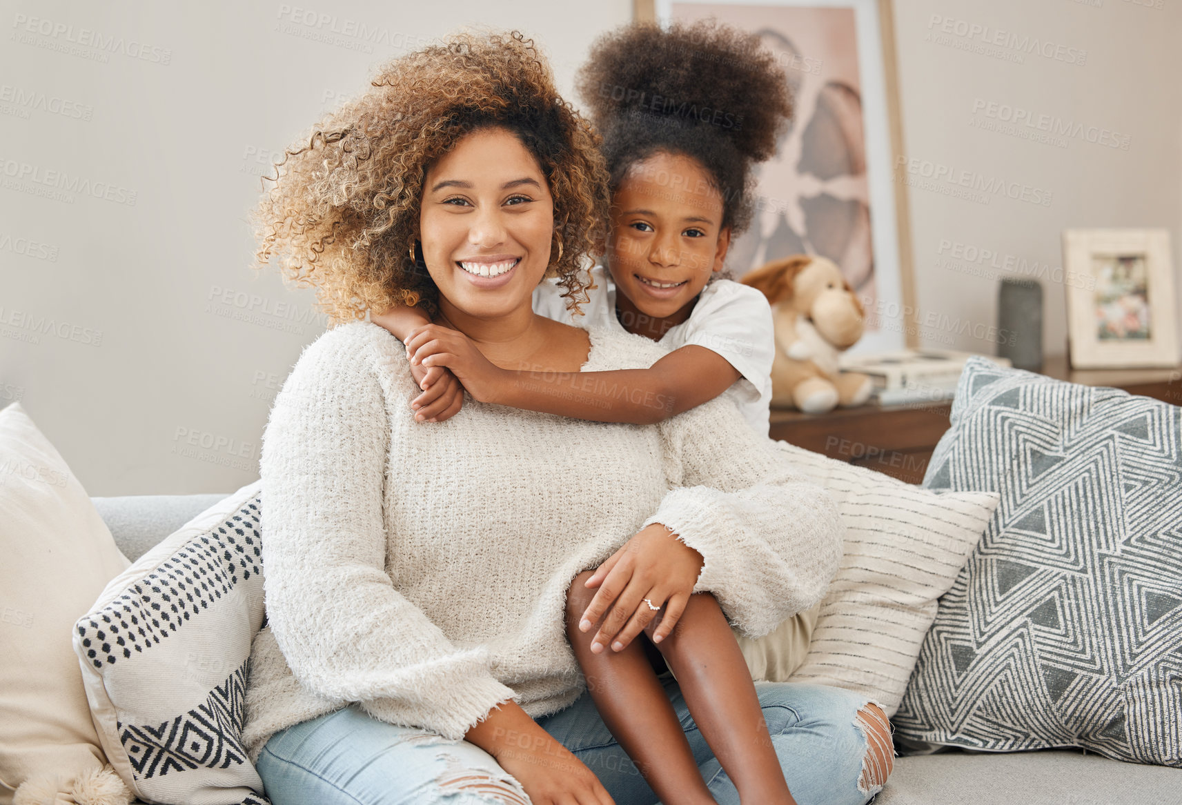 Buy stock photo Shot of a mother and daughter sitting on the couch