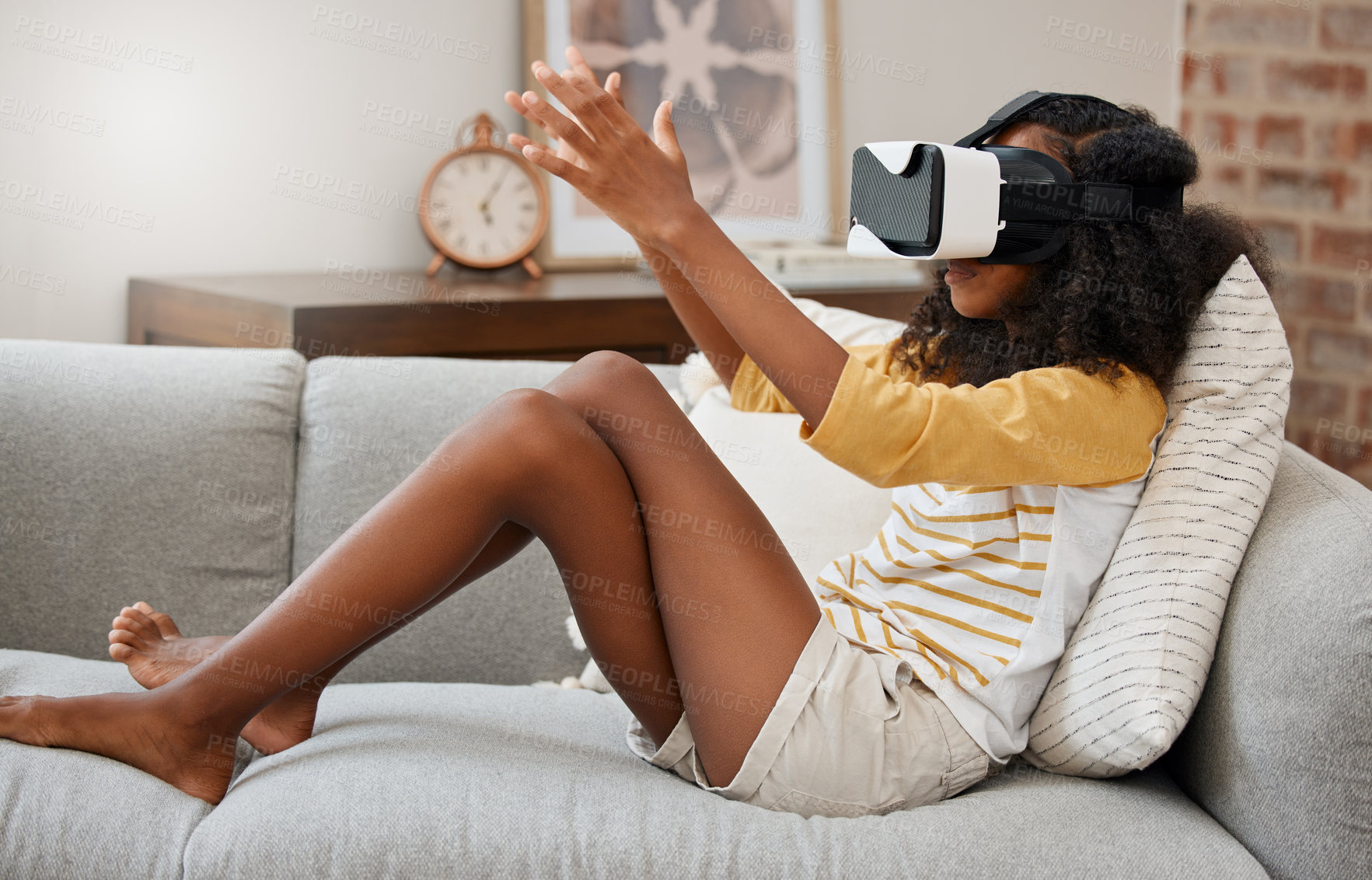 Buy stock photo Shot of a young girl playing with a vr headset at home