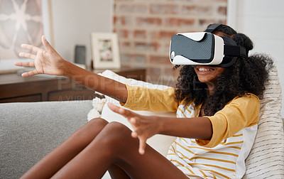 Buy stock photo Shot of a young girl playing with a vr headset at home