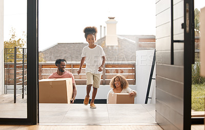 Buy stock photo Shot of a family carrying boxes into their new home