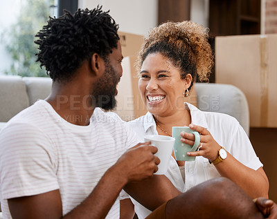 Buy stock photo Shot of a couple drinking coffee in their new home