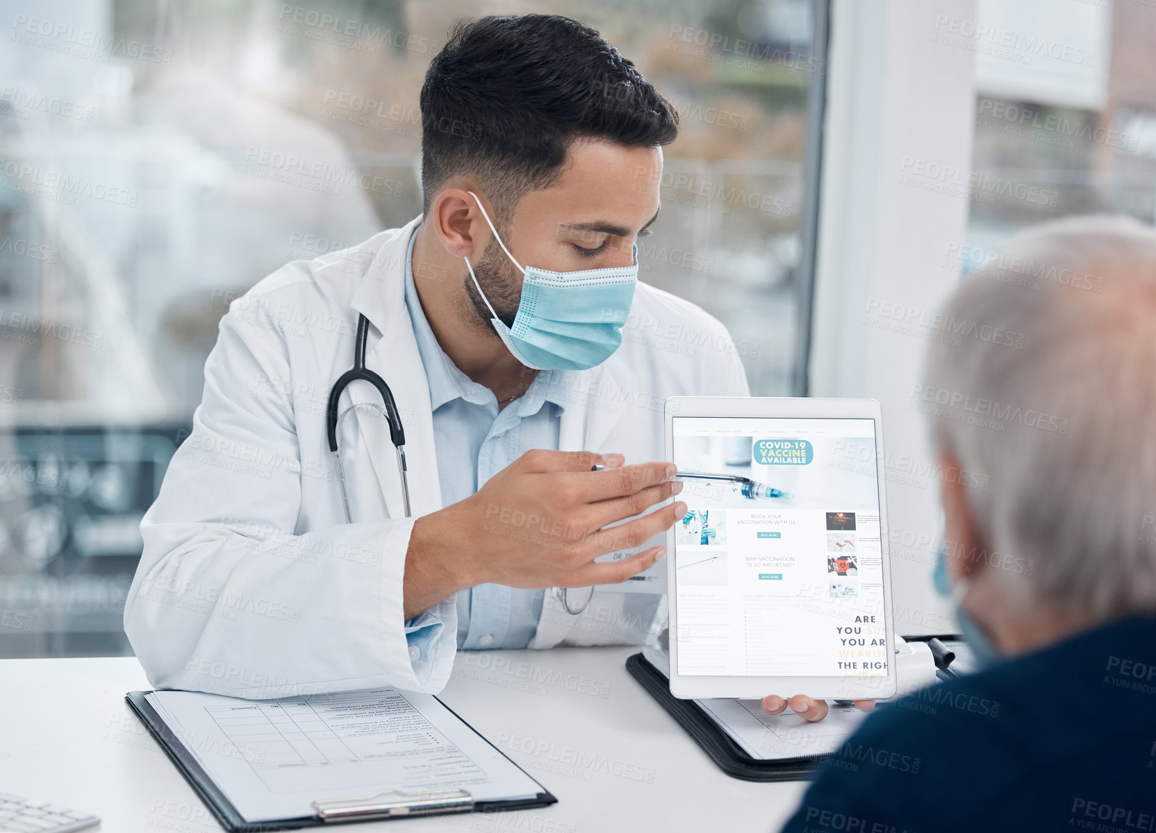 Buy stock photo Shot of a young doctor showing a patient information on a digital tablet in an office