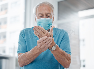 Buy stock photo Senior man, hands and joint pain or bruise in hospital, arthritis and osteoporosis or strain. Elderly male person, face mask and fibromyalgia or rheumatism, carpal tunnel and injury massage for sick