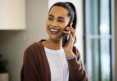 Buy stock photo Shot of a beautiful young woman talking on her cellphone at home