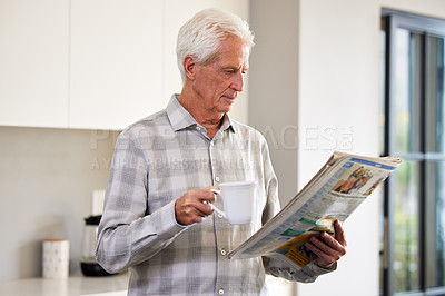 Buy stock photo Shot of a mature man reading a newspaper