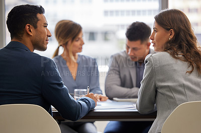 Buy stock photo Shot of a diverse group of businesspeople sitting together in the office and having a meeting