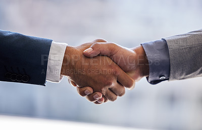 Buy stock photo Cropped shot of two unrecognizable businesspeople standing together and shaking hands in the office