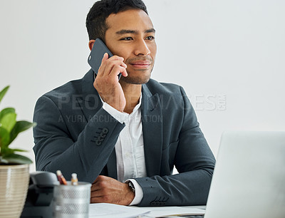 Buy stock photo Shot of a businessman during a call on his smartphone at his desk in a modern office
