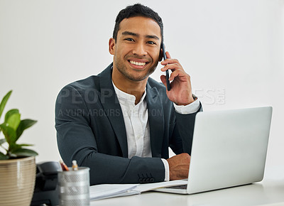 Buy stock photo Portrait of a businessman during a call on his smartphone at his desk in a modern office