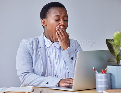 Buy stock photo Shot of a young businesswoman yawning in exhaustion