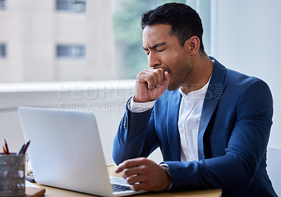 Buy stock photo Shot of a young businessman yawning while at work