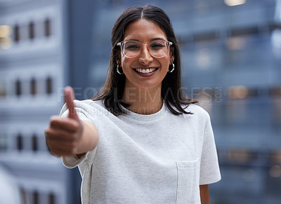 Buy stock photo Shot of a young businesswoman Showing thumbs up while standing outside the office