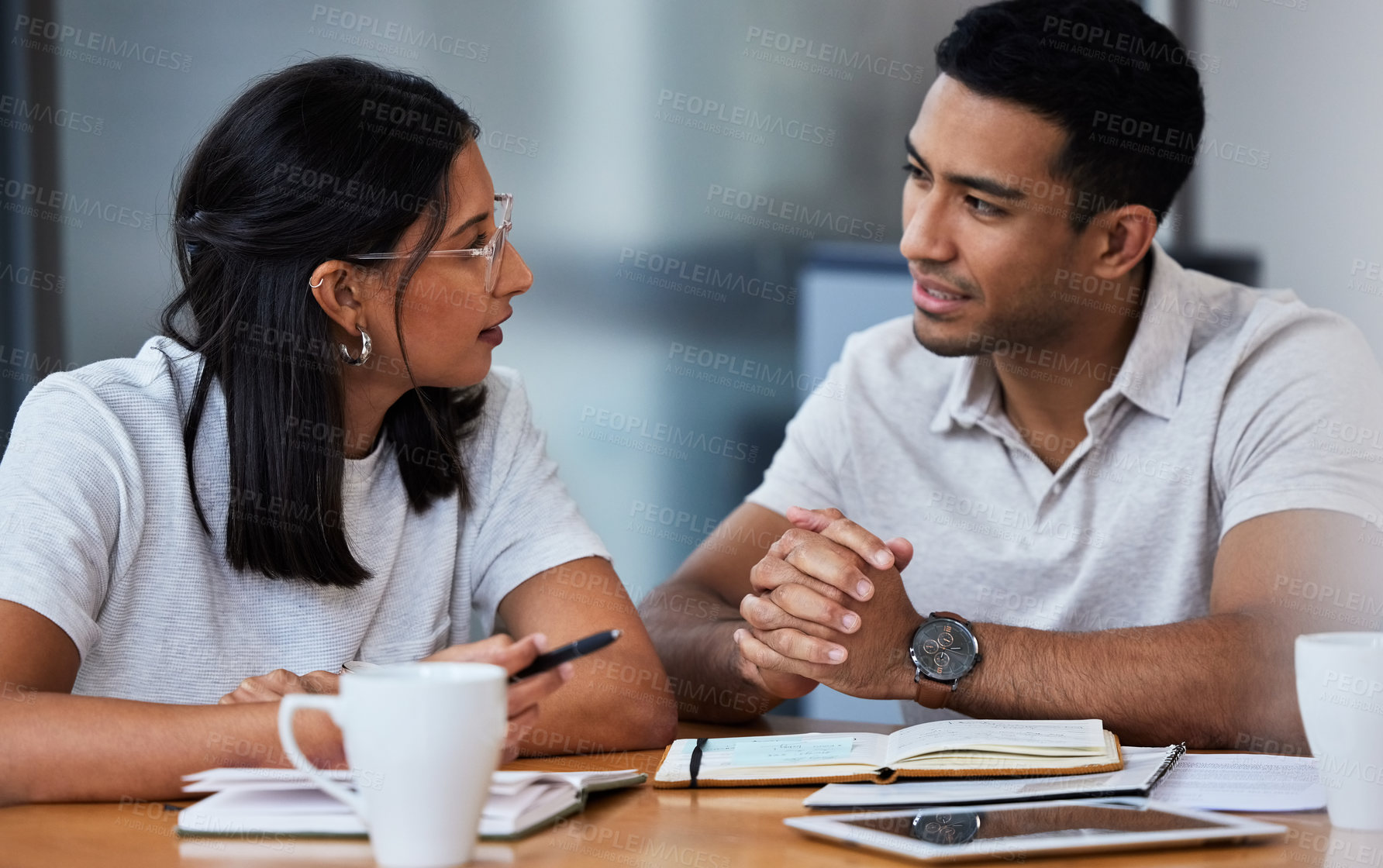 Buy stock photo Shot of two businesspeople sitting at a desk in a modern office