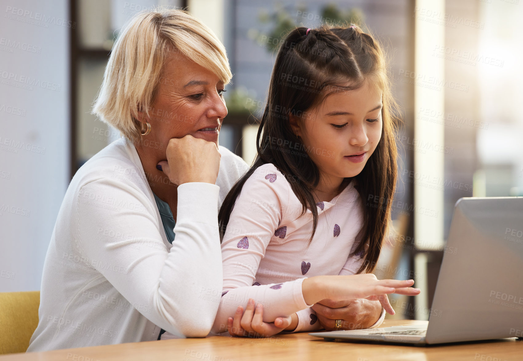 Buy stock photo Girl, grandmother and online in house with laptop for e learning, home schooling and reading e books for growth and development. Child, grandma and technology, typing and education with internet.