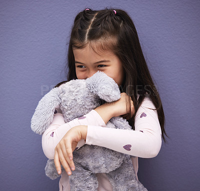 Buy stock photo Hug, child and teddy bear by purple background for love, comfort and toy for embrace or play. Mexican girl, orphan and stuffed animal by wall with happiness, kid and gift or donation for game  