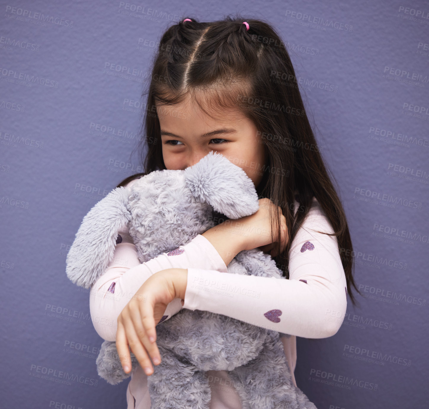 Buy stock photo Hug, child and teddy bear by purple background for love, comfort and toy for embrace or play. Mexican girl, orphan and stuffed animal by wall with happiness, kid and gift or donation for game  