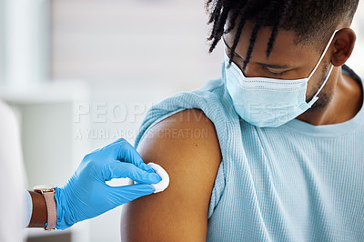 Buy stock photo Shot of a doctor holding a cotton ball against the arm of her patient