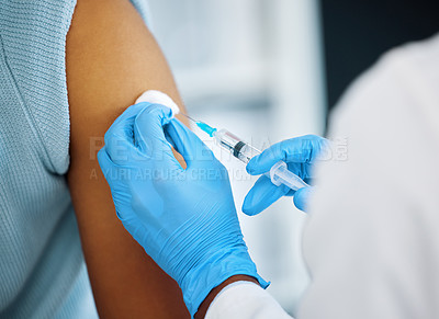 Buy stock photo Shot of a doctor giving her patient an injection