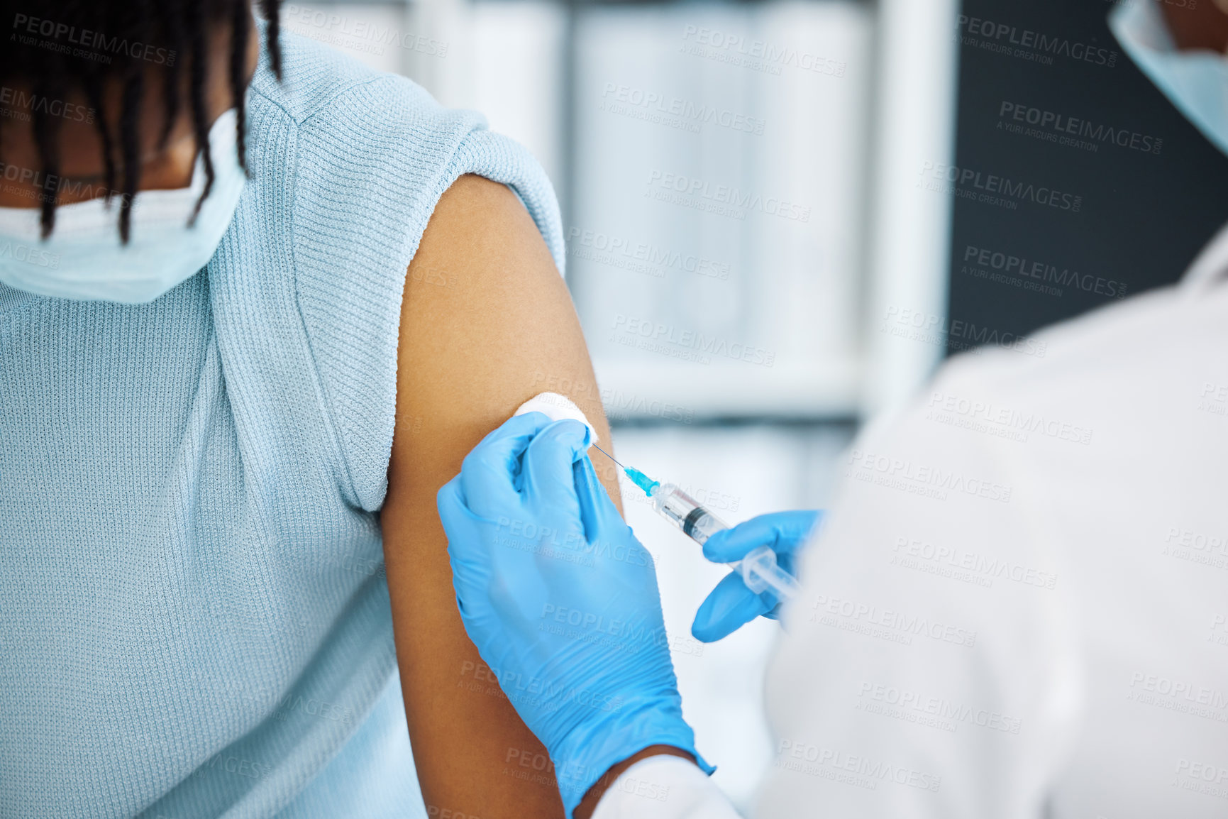 Buy stock photo Shot of a doctor giving her patient an injection