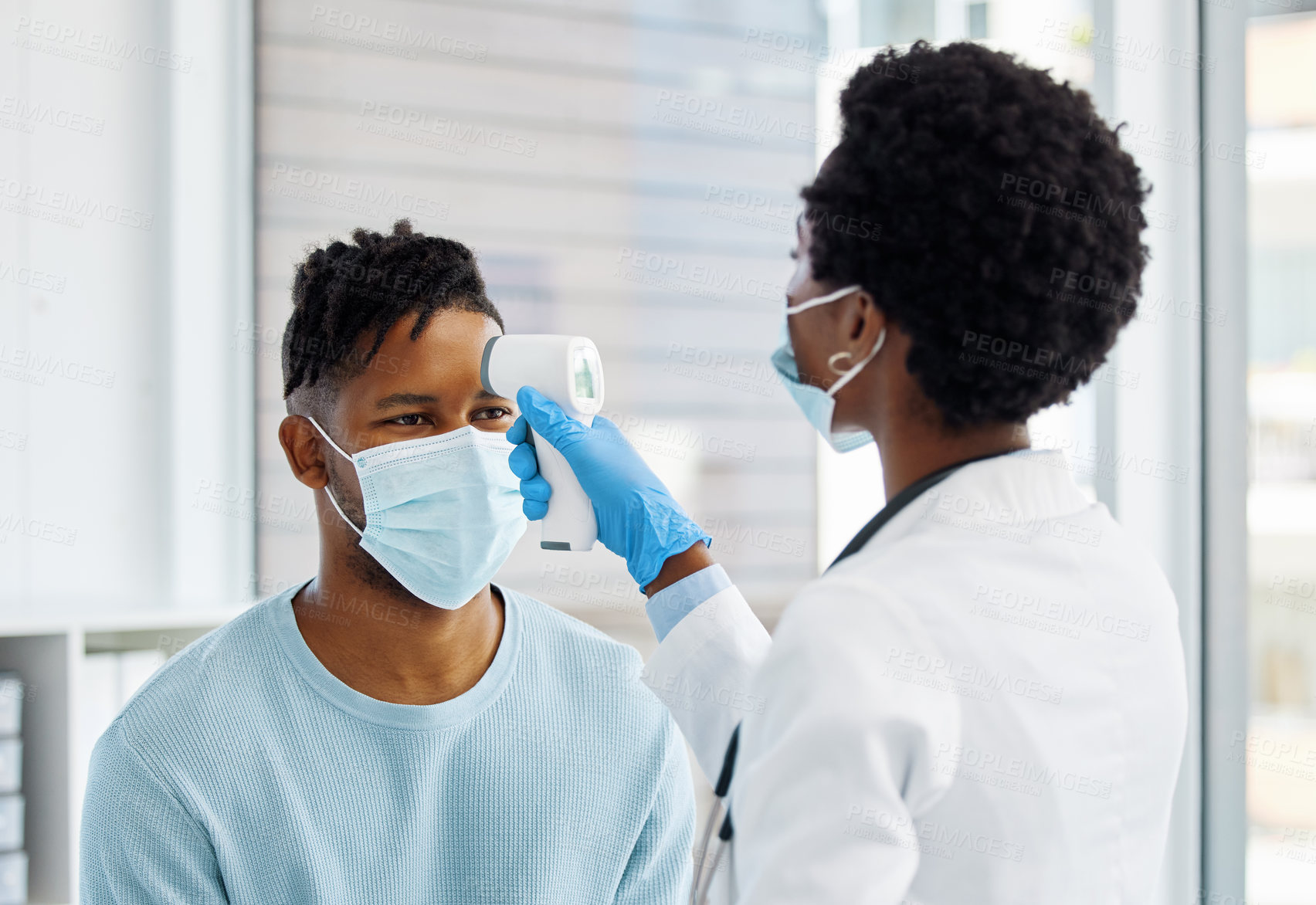 Buy stock photo Shot of a female doctor taking the temperature of her patient