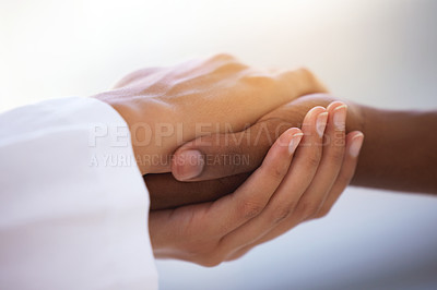 Buy stock photo Shot of an unrecognizable doctor holding hands with her patient during a consultation