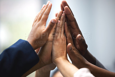 Buy stock photo Shot of a group of unrecognizable businesspeople holding up their hands for a high five in an office