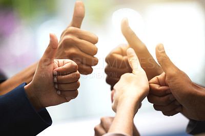Buy stock photo Shot of a group of unrecognizable businesspeople showing thumbs up in an office