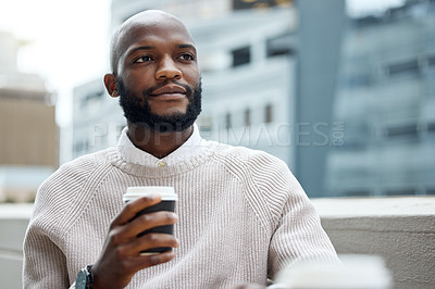 Buy stock photo Shot of a young businessman looking thoughtful while drinking coffee outside an office
