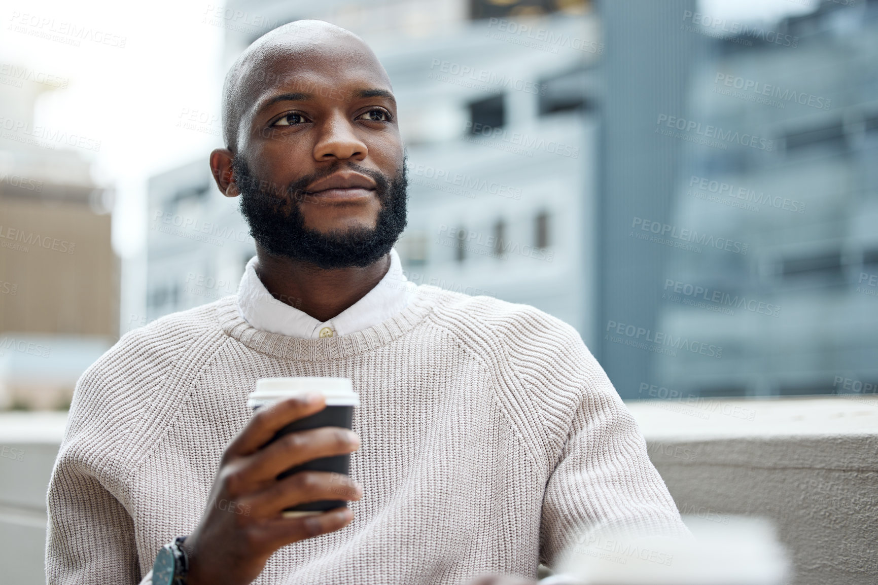 Buy stock photo Shot of a young businessman looking thoughtful while drinking coffee outside an office