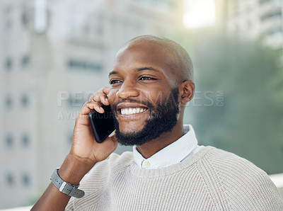 Buy stock photo Cropped shot of a handsome young businessman making a phonecall while standing on the balcony of his office