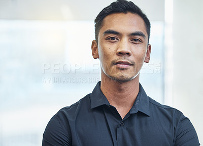 Buy stock photo Cropped portrait of a handsome young businessman standing in his office