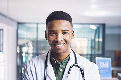 Buy stock photo Cropped portrait of a handsome young male doctor standing in the hospital