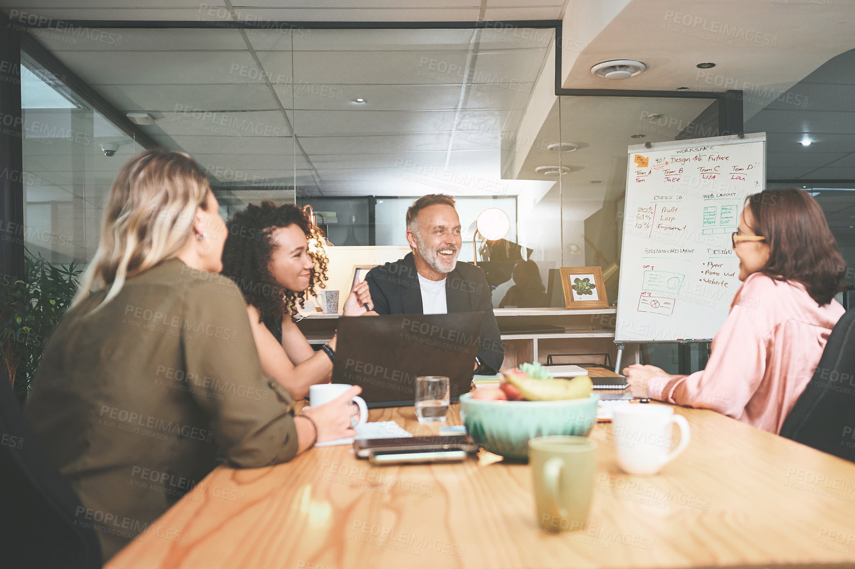 Buy stock photo Shot of a diverse group of businesspeople sitting together in the office and having a meeting