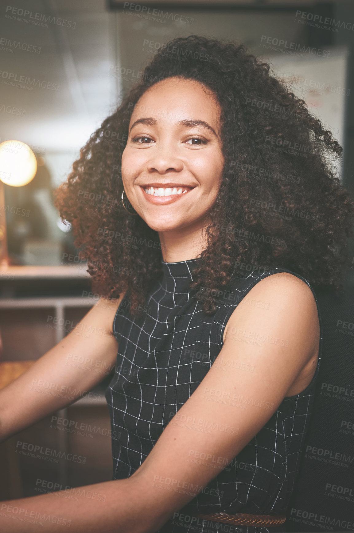 Buy stock photo Shot of an attractive young businesswoman sitting alone in the office at night