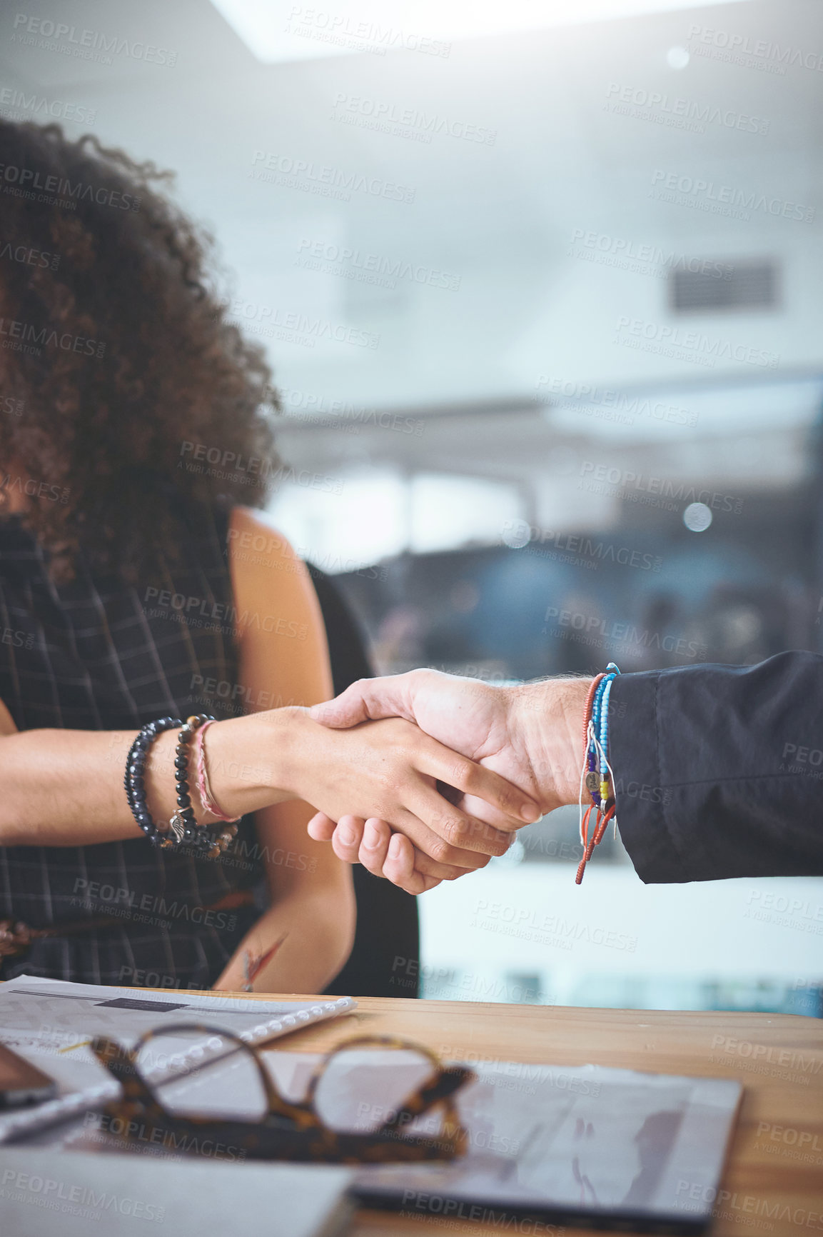 Buy stock photo Cropped shot of two unrecognizable businesspeople shaking hands during a meeting in the office