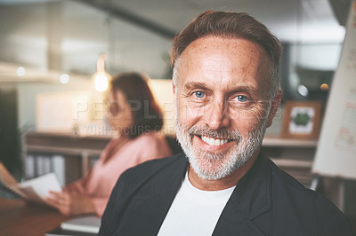 Buy stock photo Shot of a handsome mature businessman sitting in a meeting at the office